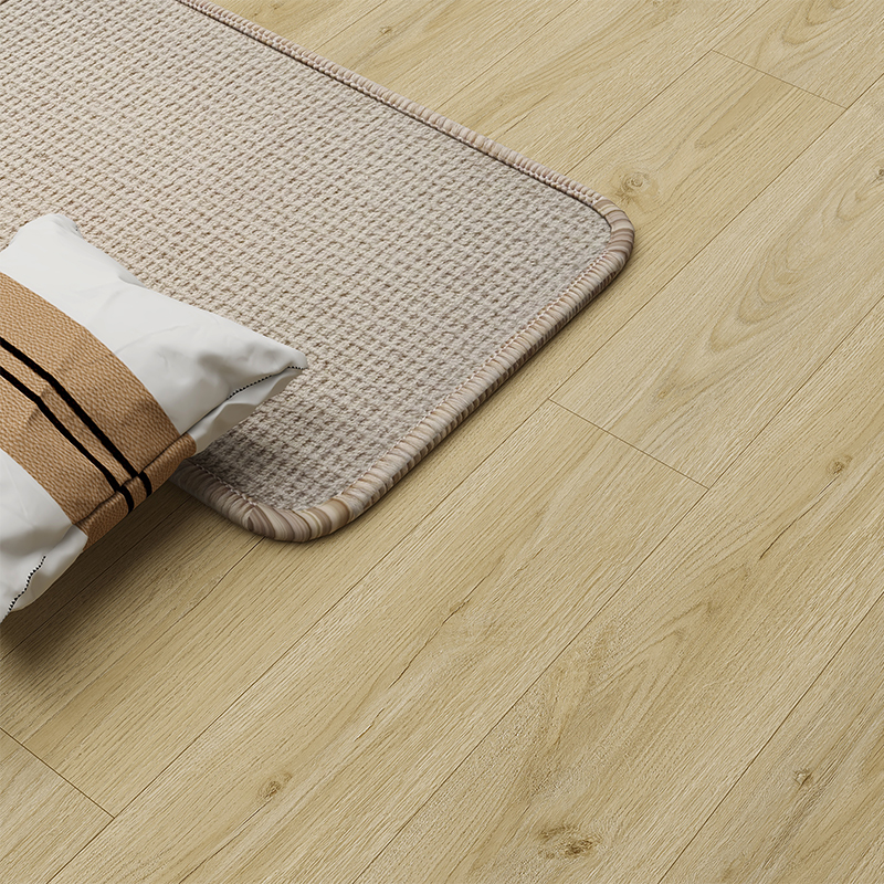 Wood look plank style laminate flooring installed in a bright interior space